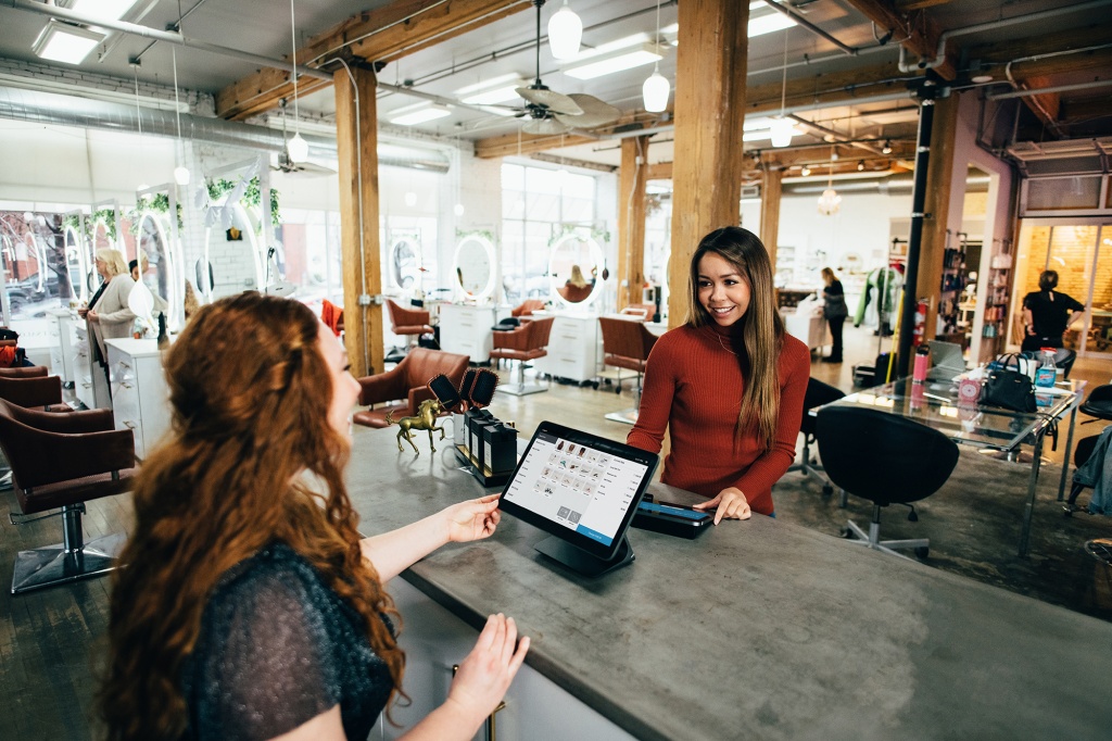Two people talking in a shop about SaaS software